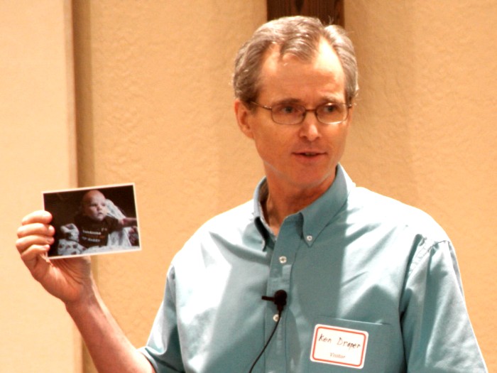 Guest Speaker Pastor Ken Draper showing his new grandchild's photo before preaching
 "If You Want to Please God..." - 8/29/10